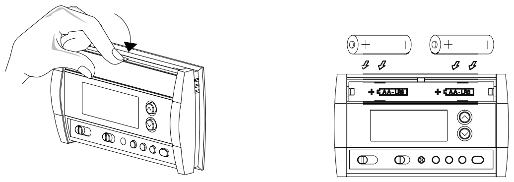 Removing the battery cover and installing two AA batteries in the polarity shown
